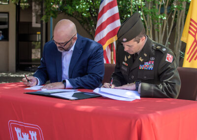 two men signing documents